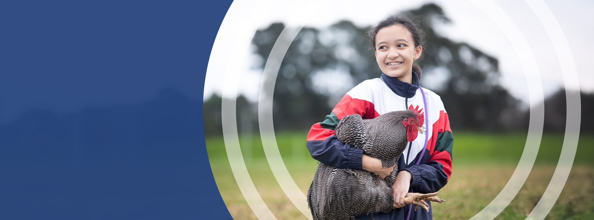 Student holding a chicken in the school farm at St John Paul II Catholic College Schofields
