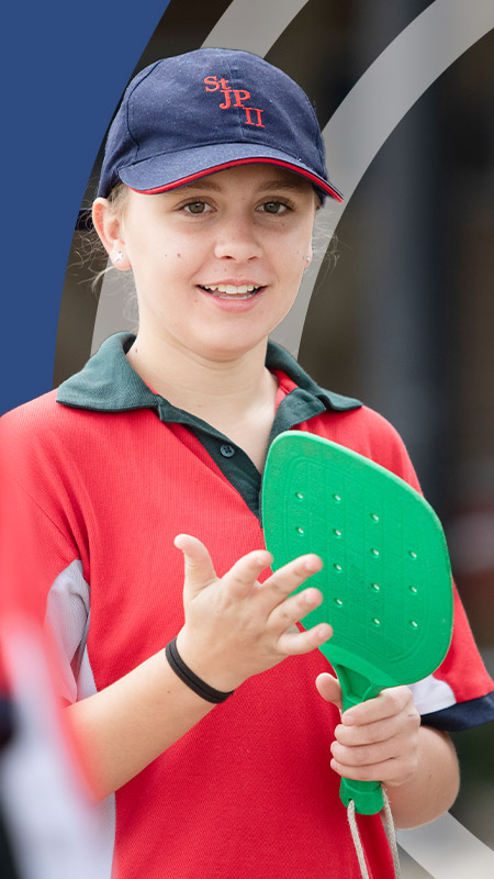 Student playing mini tennis during sport at St John Paul II Catholic College Schofields