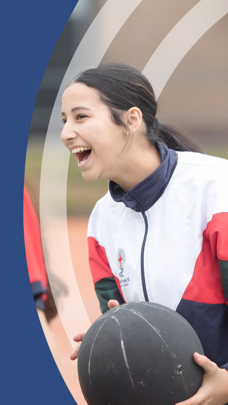 Student playing basketball on the basketball court at St John Paul II Catholic College Schofields