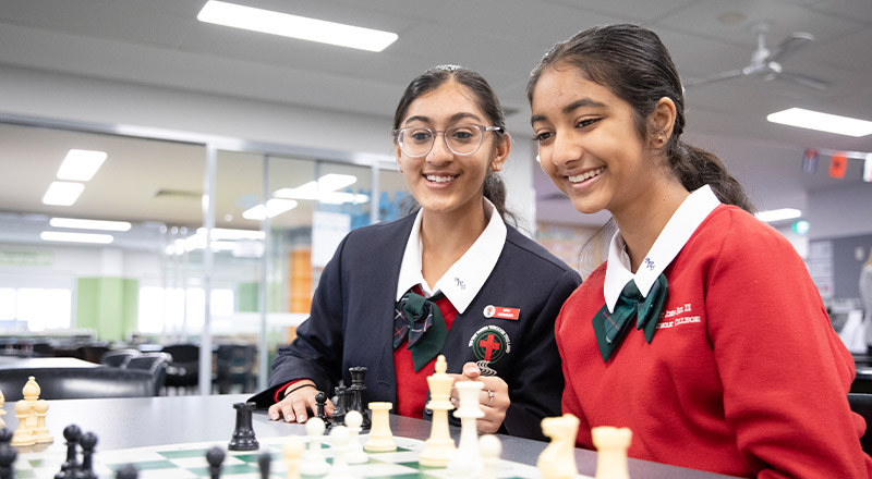 Students playing chess together at St John Paul II Catholic College Schofields and Nirimba