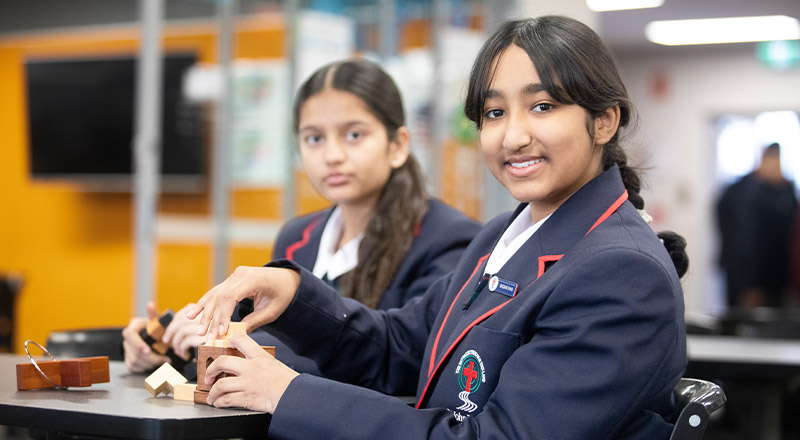 Students sitting together in the library at St John Paul II Catholic College Schofields