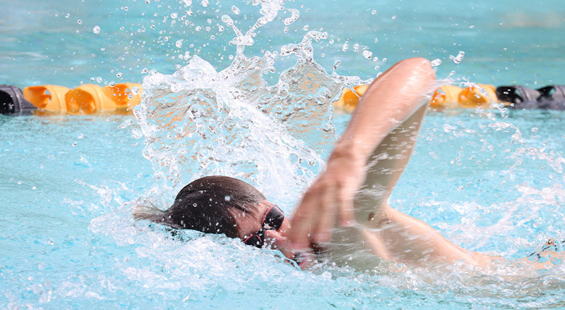 Student swimming in a pool at St John Paul II Catholic College Schofields swim carnival
