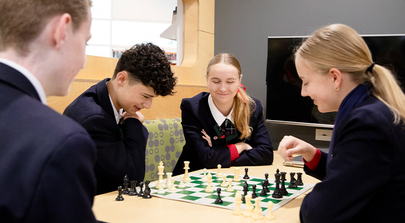 Students playing chess together at St John Paul II Catholic College Schofields and Nirimba
