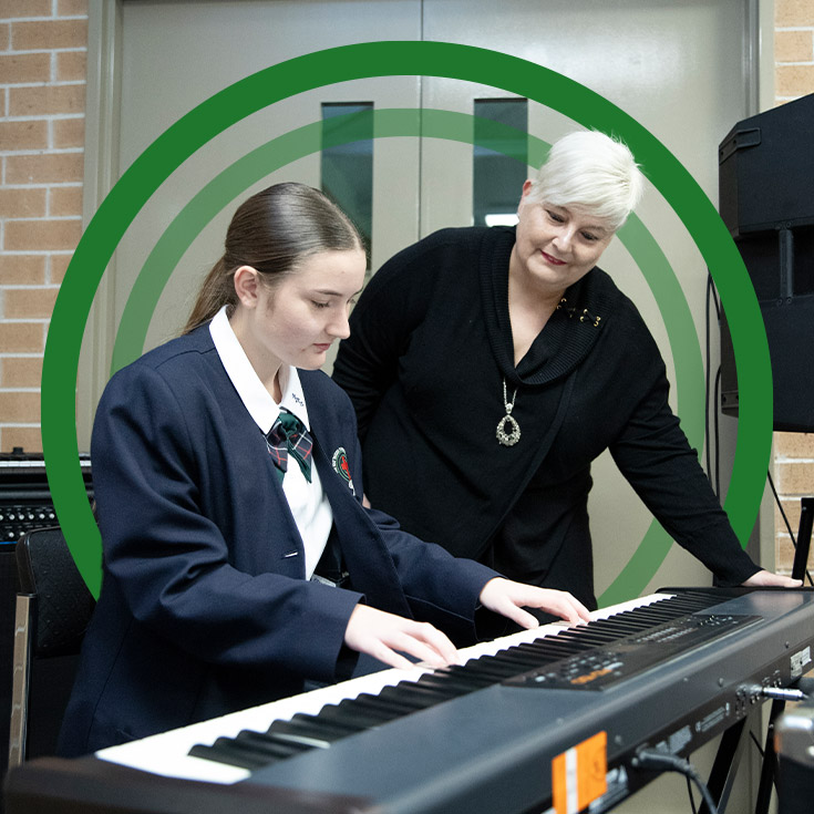 Student with her teacher learning how to play the keyboard at St John Paul II Catholic College Schofields