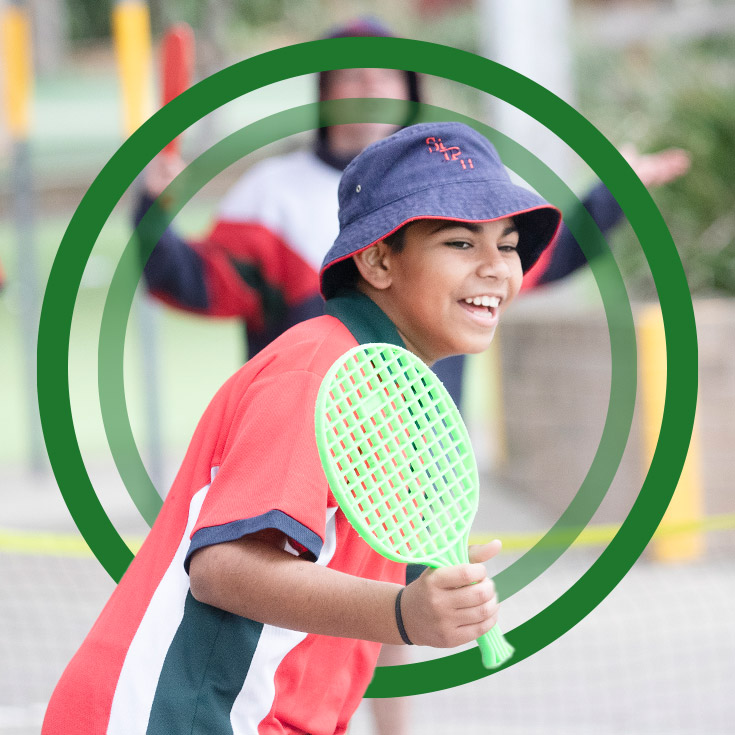 Student playing mini tennis during sport at St John Paul II Catholic College Schofields
