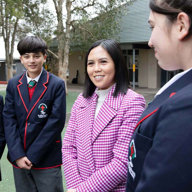 Teacher with her students in the school grounds at St John Paul II Catholic College Schofields